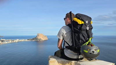 Riku sitting on a rock looking out at the sea