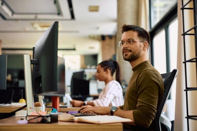 Man at the office working behind a computer
