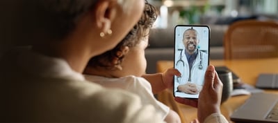 Womand and her child are having a video call with the doctor
