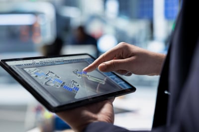 Person holding tablet with data on the screen